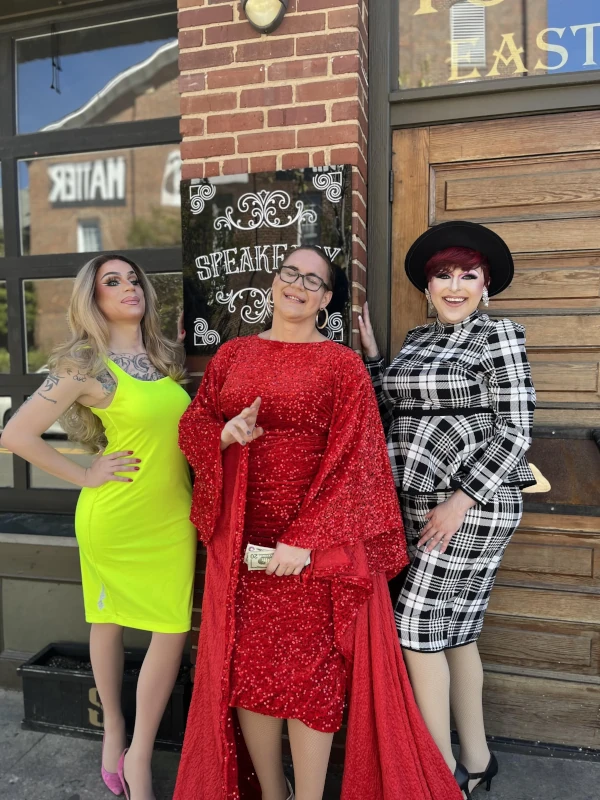 Three people standing infront of the Speakeasy in Carrboro