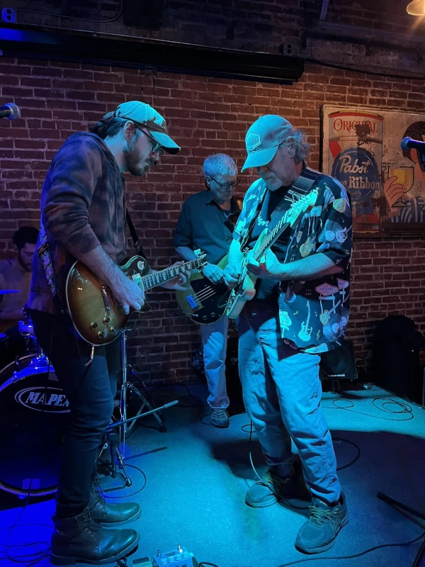 Group of people playing guitar on stage