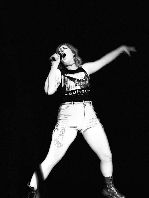Black and white photo of passionate singer on stage of Speakeasy in Carrboro