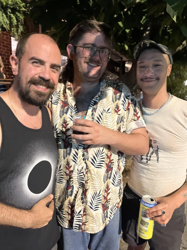 Three people posing outside of Speakeasy in Carrboro