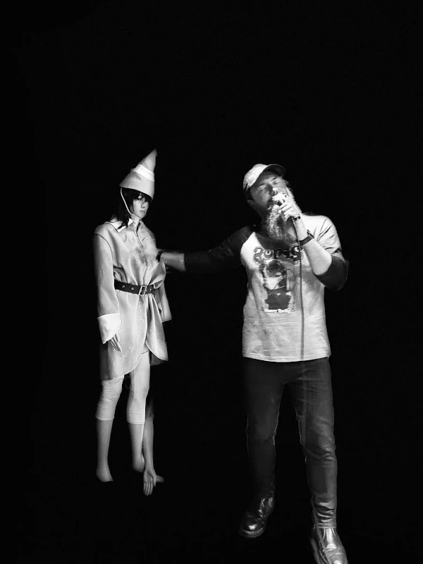 Black and white photo of two people performing on stage at the Speakeasy in Carrboro