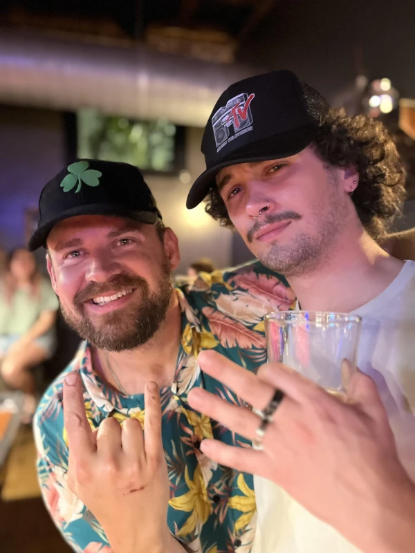 Two men posing for the camera and smiling at Speakeasy in Carrboro